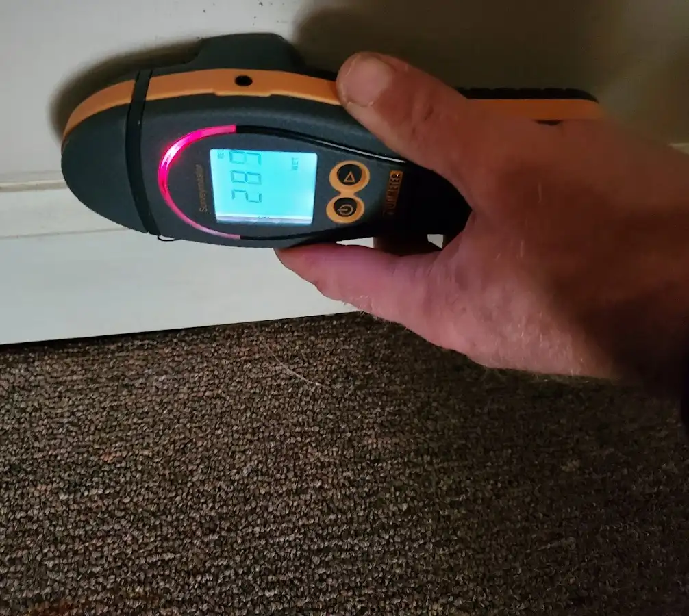 Moisture detection at baseboard during Storm Damage Restoration in Poolesville